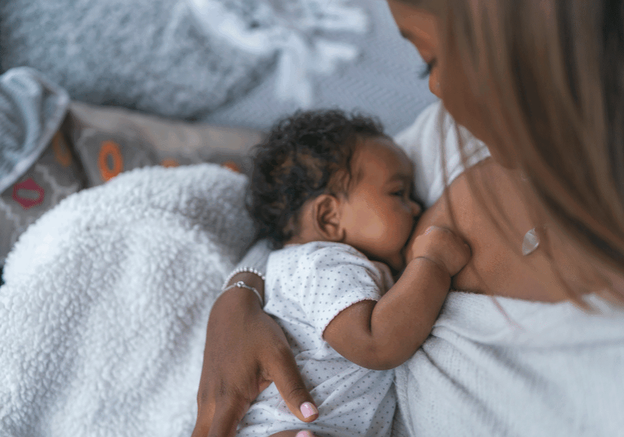 A parent feeding and soothing their newborn.